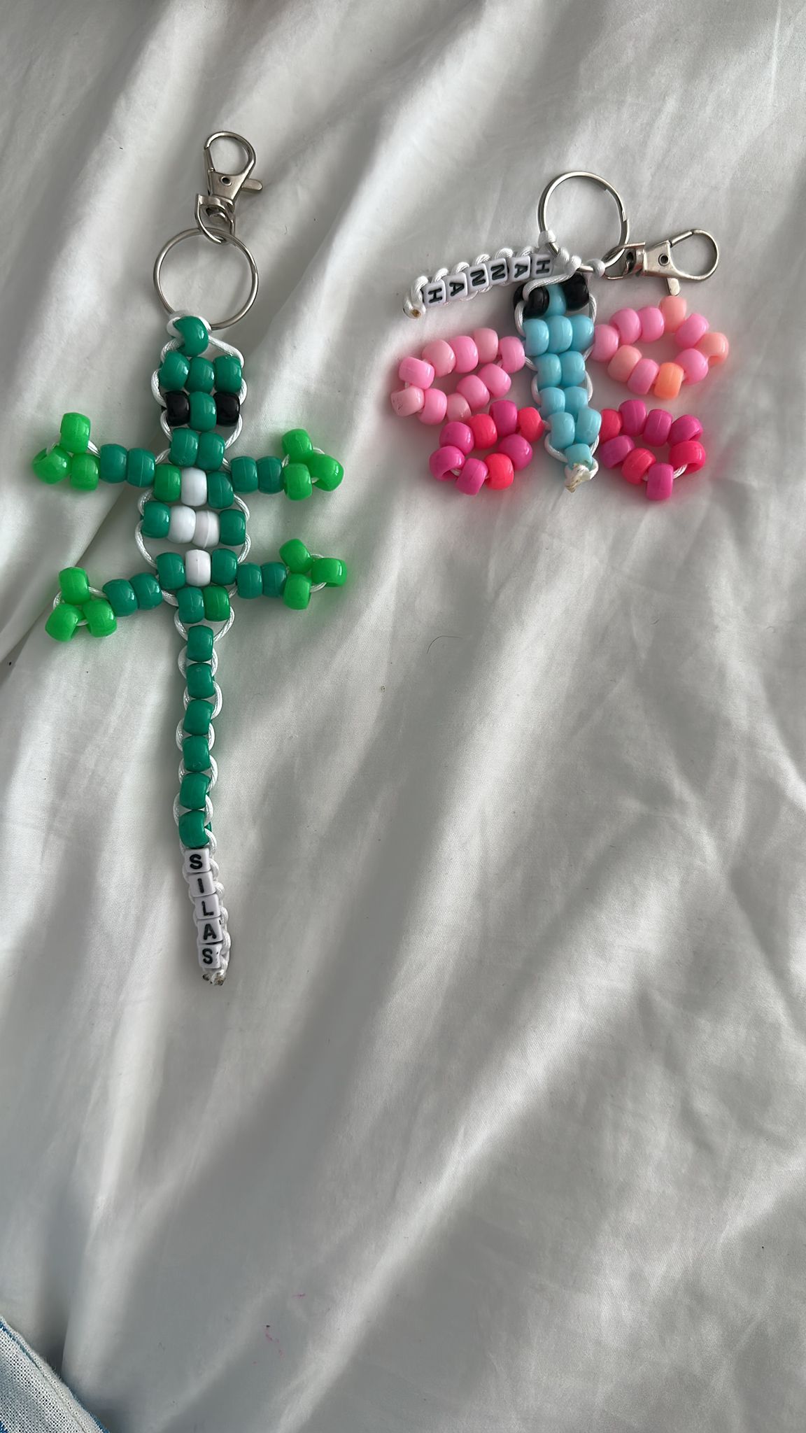 Handmade beaded gecko and butterfly displayed together