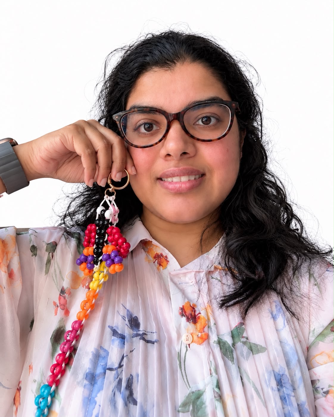 Gladlyn, founder and maker of Forever Beaded, holding a colourful handmade Forever Beaded keychain.