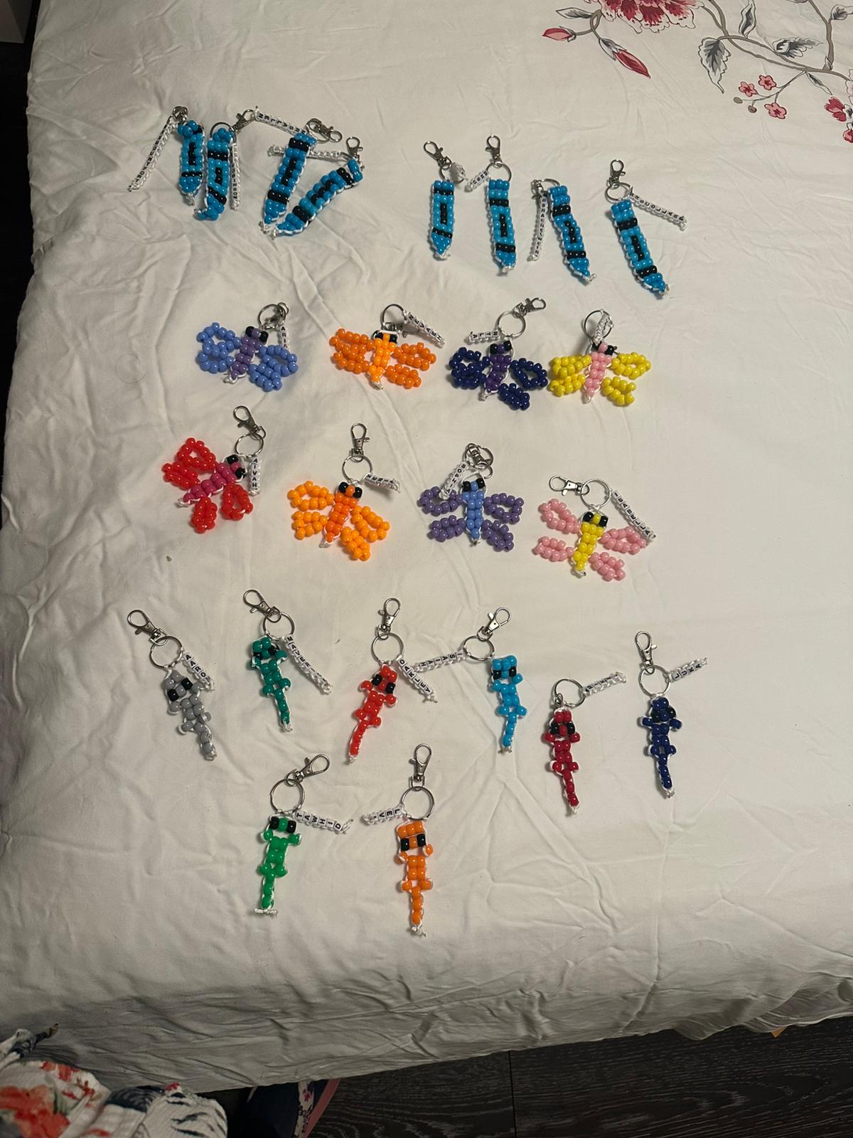 Collection of pencils, butterflies, and baby gecko beadwork